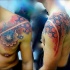 Colored and detailed chest and shoulder tattoo of ancient ornaments