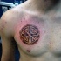 Colored funny looking chest tattoo of of Celtic symbol