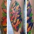 Colored graffiti style leg tattoo of typical lettering