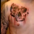 Colored horror style creepy looking chest tattoo of human skull