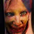 Colored horror style creepy looking woman face tattoo