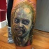 Colored horror style realistic looking leg tattoo of evil monster portrait