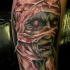 Colored illustrative style leg tattoo of creepy mummy