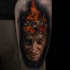 Colored incredible looking thigh tattoo of mn with burning head
