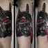 Colored mystical looking biceps tattoo of demonic face