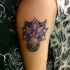 Colorful big lotus flower tattoo on shoulder combined with small moon