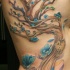Tatuaggio simpatico sul fianco l'albero con i fiori azzurri