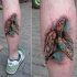 Colorful leg muscle tattoo of swimming turtle