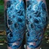 Colorful mystical looking leg tattoo of smoke like skull
