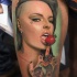 Colorful realism style biceps tattoo of sexy woman with strawberry