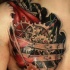 Coloured biomechanisms tattoo on chest