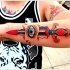 pugnale colorato con occhio avambraccio tatuaggio