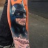 Comic books style colored leg tattoo of Batman and lettering