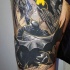 Comic books style colored thigh tattoo of creepy looking Batman in night city