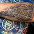 Cool eagle shaped black ink forearm tattoo stylized with tribal ornaments