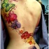 idea fresca di fiori orchidee tatuagio colorato sulla schiena