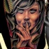 Creepy looking colored arm tattoo of seductive woman with leaves