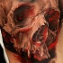 Creepy looking colored realism style shoulder tattoo of corrupted human skull