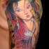 Cute cartoon like colored shoulder tattoo of Asian geisha portrait and flowers