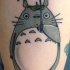 Cute cartoon style small funny animal with umbrella tattoo