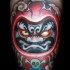 Cute colored fantasy evil daruma doll tattoo on leg