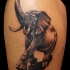 Cute looking colored cartoon style tattoo of walking elephant