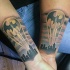 Cute looking colored forearm tattoo of night city with Batman symbol
