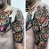 Cute looking colored shoulder and chest tattoo of tiger family