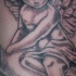 Tatuaje  de querube con ojos cerrados