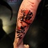 Dark black ink Asian hieroglyphs tattoo on calf with colored paint drips