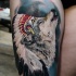 Detailed and colored realism style thigh tattoo of wolf in Indian helmet
