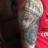 Detailed black and white shoulder tattoo of old Roman arena with gladiator warrior