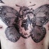 Detailed Engraving style chest tattoo of human heart stylized with world map and wings