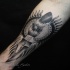 Detailed engraving style forearm tattoo of demonic knife with lettering and sun