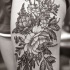Tatuaje  de planta con flores en la pierna