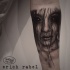 Detailed mystical looking forearm tattoo of demonic woman face