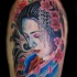 Dramatic natural colored shoulder tattoo of sad geisha portrait
