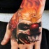 terribile pagliaccio in fuoco tatuaggio sul mano da Kyle Cotterman