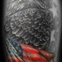 Eagle wrapped in american flag tattoo on arm