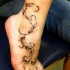 vite elegante tatuaggio sul piede
