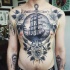 Engraving style black and white chest tattoo of sailing ship with anchor and roses