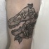 Engraving style black ink arm tattoo of dinosaur skeleton and rose