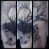 Engraving style black ink arm tattoo of old elk with sun