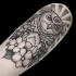 Engraving style black ink arm tattoo of fantasy owl with flowers