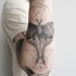 Engraving style black ink arm tattoo of mystical creature with lines