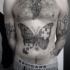 Engraving style black ink belly tattoo of butterfly made from puzzle