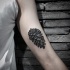Engraving style black ink biceps tattoo of fir-cone