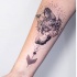 Engraving style black ink forearm tattoo of wolf head with ornaments