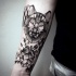 Engraving style black ink forearm tattoo of wolf head with stone human heart