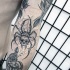Engraving style black ink forearm tattoo of spider with human skull